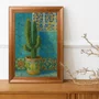 Quadro Decorativo Cacto Ornamental em Vaso Maiólica Contra Parede de Azulejos Azul-Turquesa